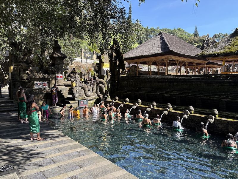 Worshippers performing melukat ritual purification at the Tirta Empul water temple, Bali