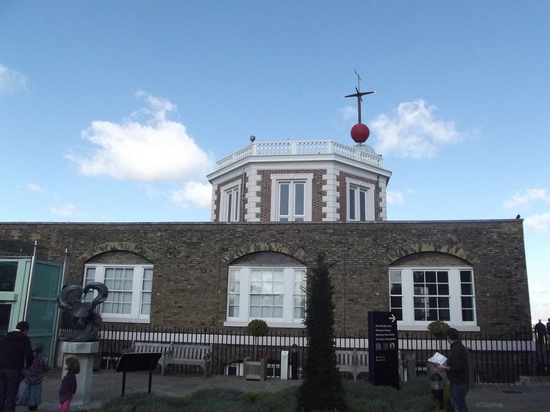 Flamsteed House at the Royal Observatory Greenwich in London, with its red time ball on the mast above the octagonal turret