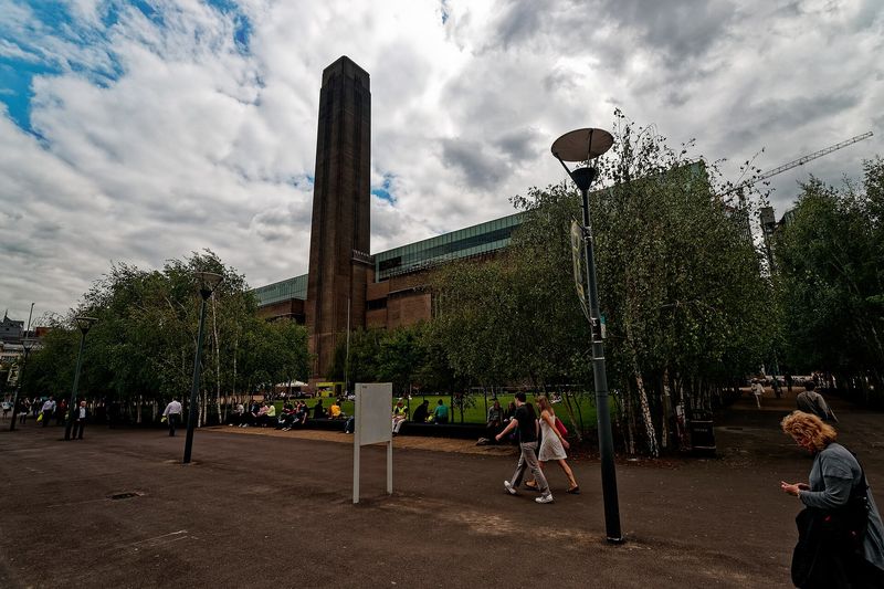 Tate Modern, the former Bankside Power Station, with its tall central brick chimney rising above the riverside gallery on London's South Bank
