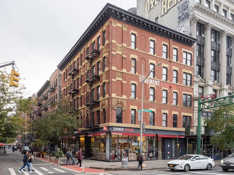 The red-brick corner tenement building housing the Tenement Museum on the Lower East Side, New York City