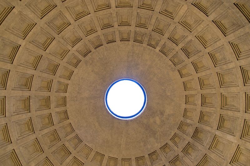 The Pantheon's coffered concrete dome seen from within, open to the sky through its single round oculus, Rome