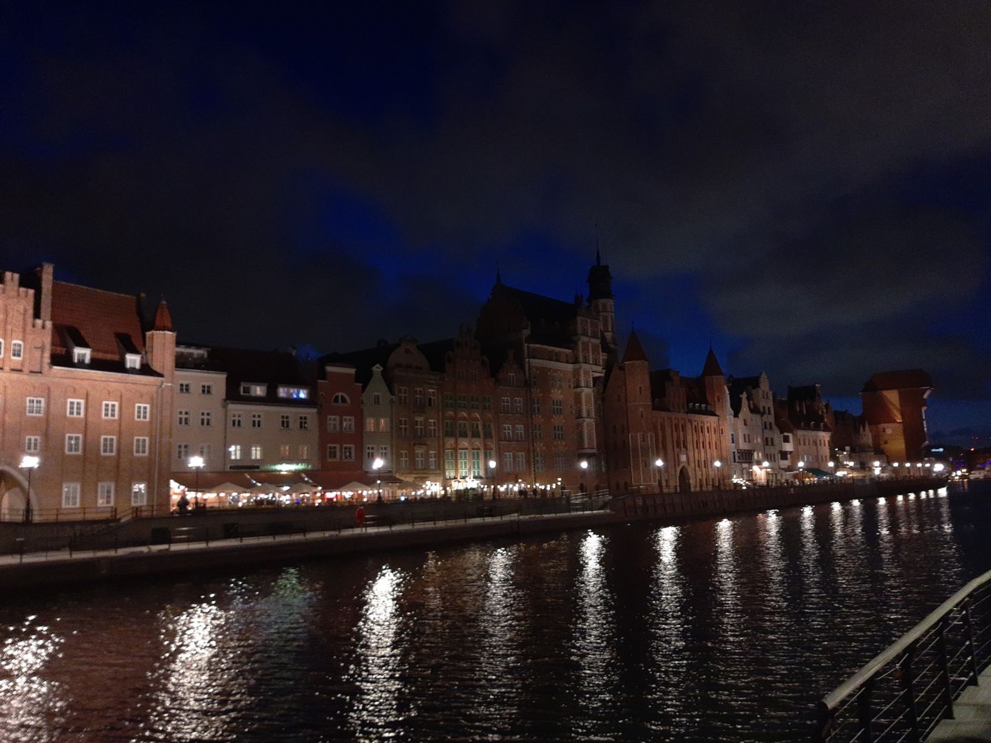 Pastel-coloured merchant houses and the medieval Gdansk Crane rising above the Motlawa River in Gdansk's Old Town, Poland